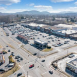 Drone view of Lake Drive Plaza shopping center and nearby intersection.