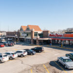 Drone view of Rushville Plaza Auto Zone and Kroger storefronts.