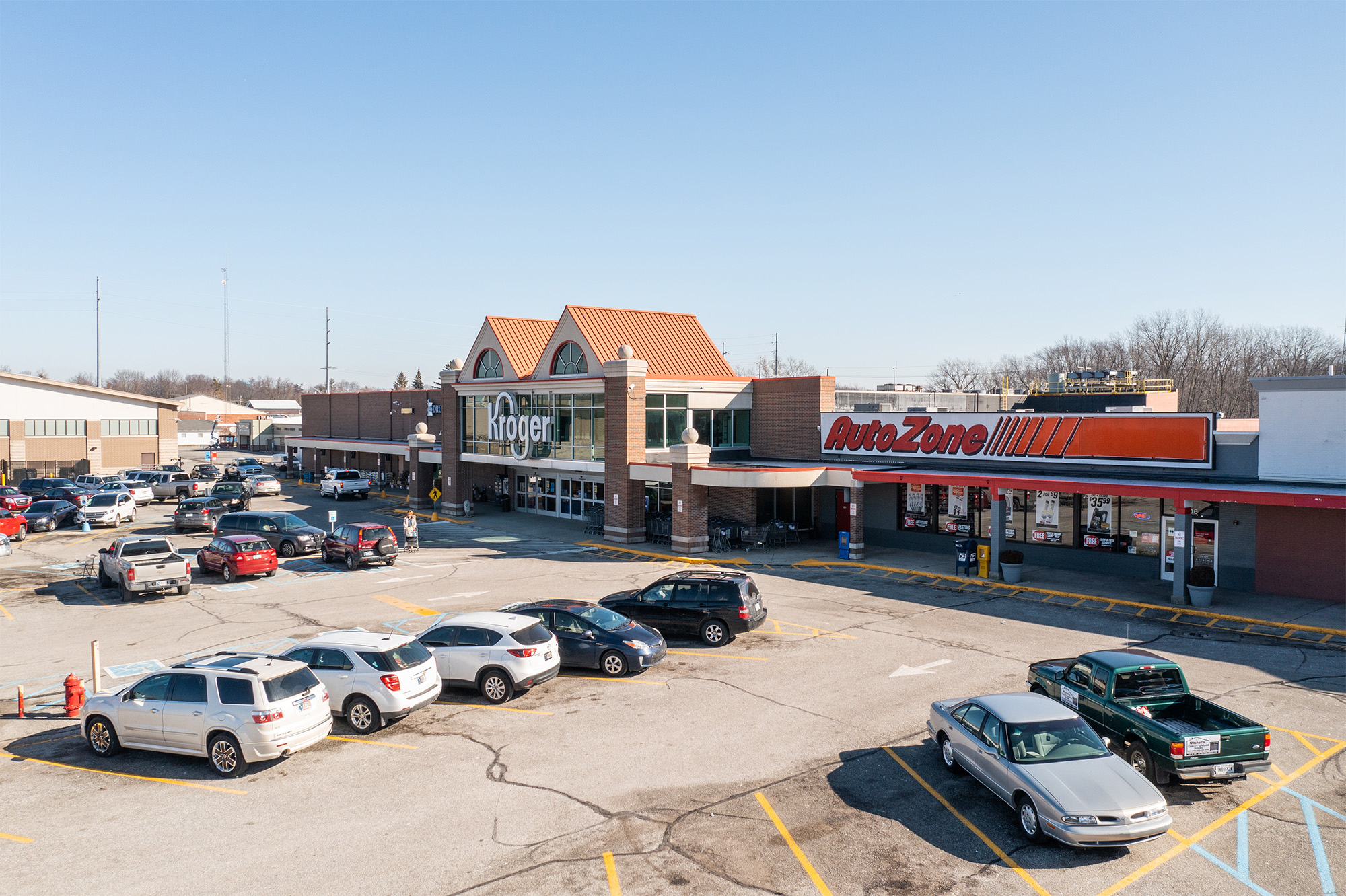 Drone view of Rushville Plaza Auto Zone and Kroger storefronts.