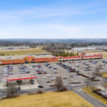 Drone view of Shoppes of Mason storefronts and Kroger gas station.