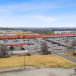 Drone view of Shoppes of Mason storefronts and Kroger gas station.