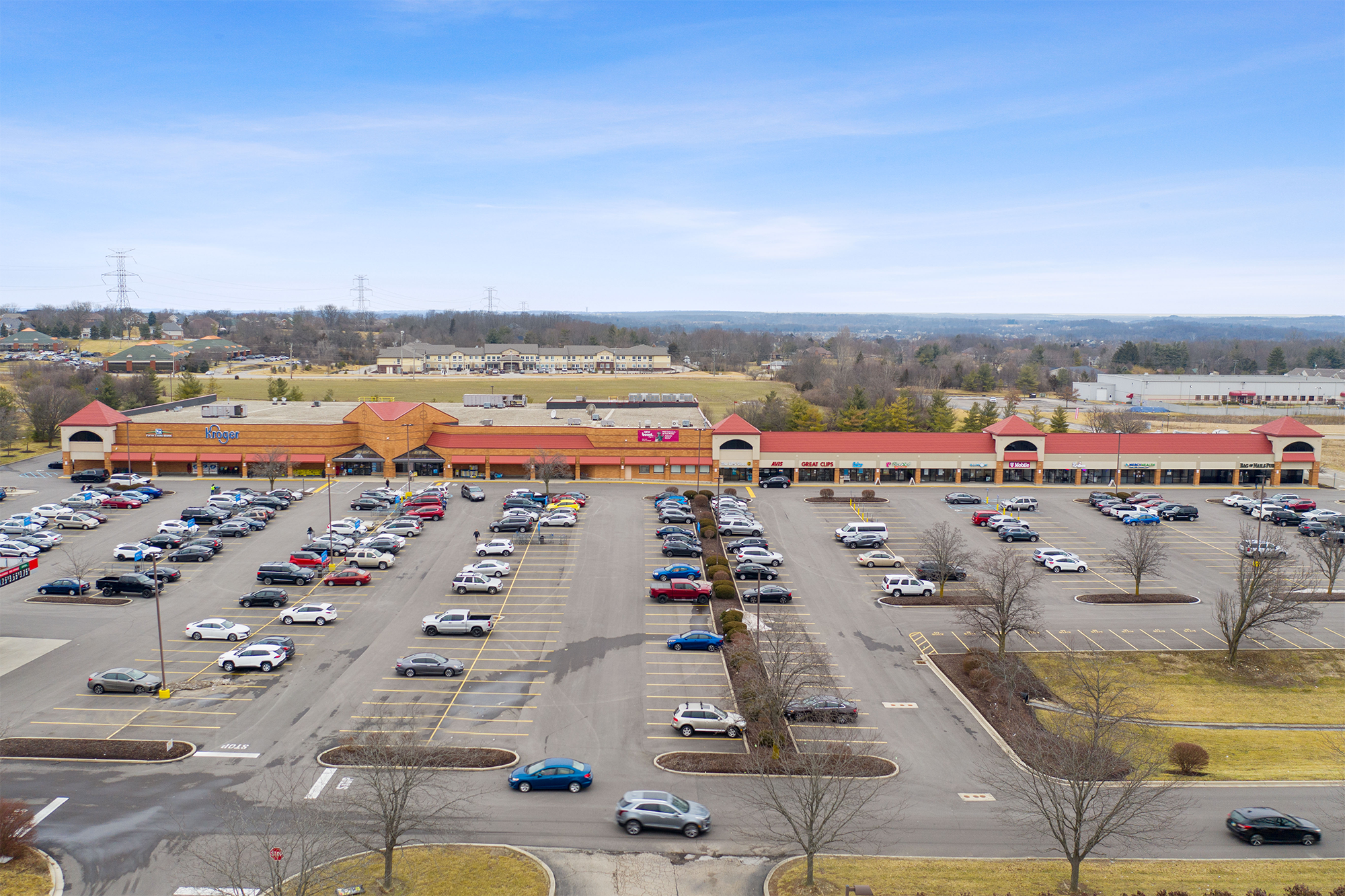 Drone view of Shoppes of Mason storefronts and parking.