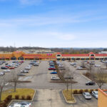 Drone view of Shoppes of Mason storefronts and parking.