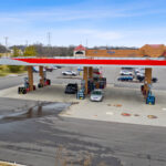 Drone view of Shoppes of Mason storefronts and Kroger gas station.