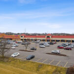 Shoppes of Mason drone view of storefronts and parking.