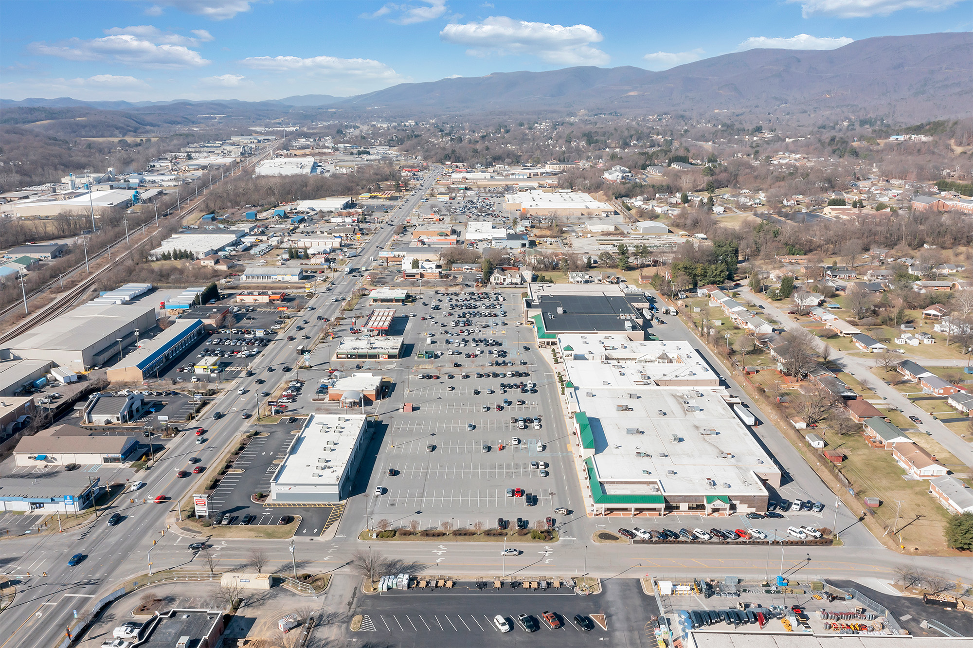 Drone view of Spartan Square and Main St with mountains in the distance.