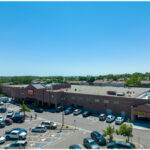 Cheyenne Meadows, King Sooper, US Bank, Starbucks, and Dickey's Barbecue Pit parking lot, aerial view.