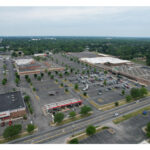 Woodland Crossing aerial view from behind Kroger, full shopping center and parking lot.