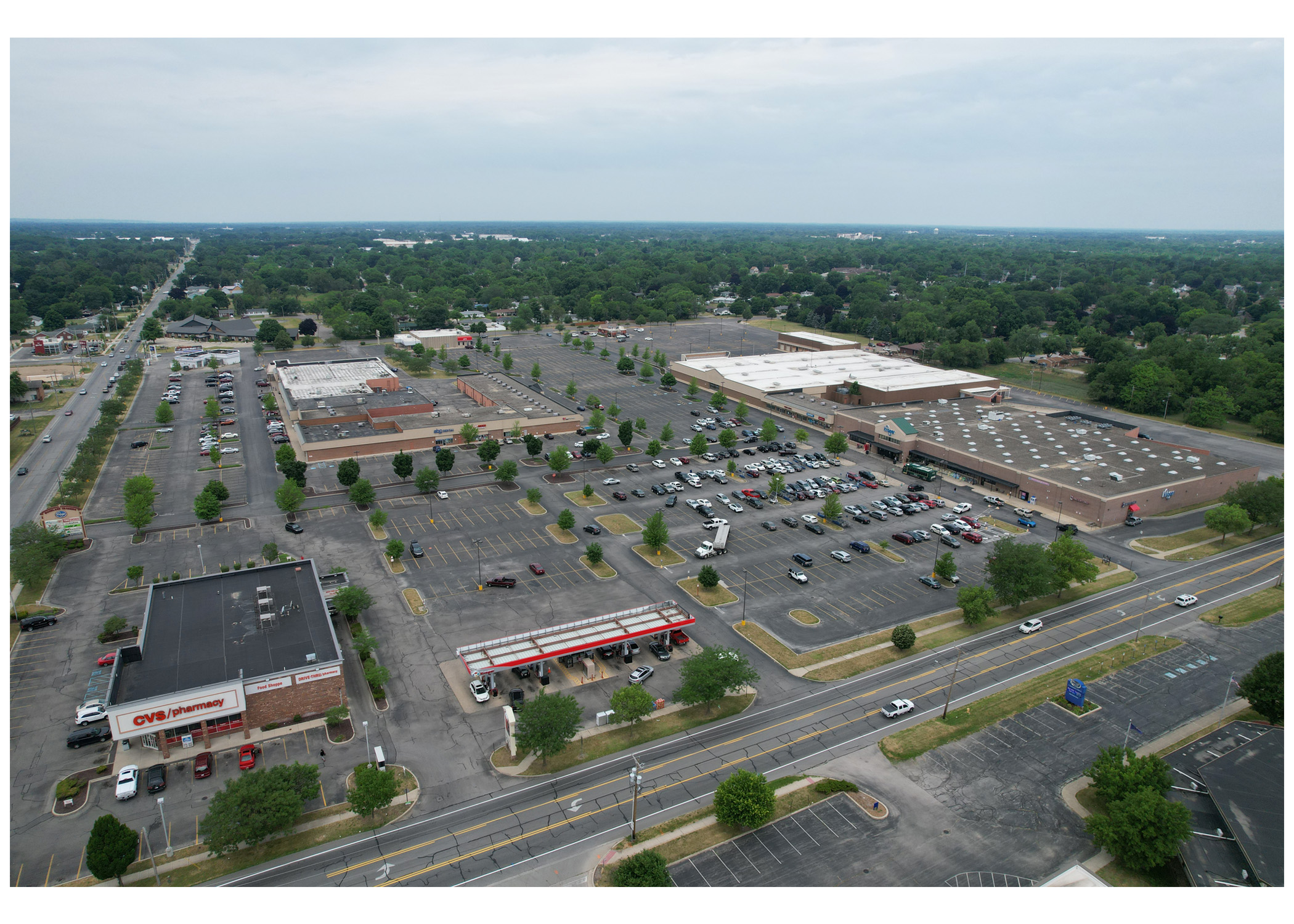 Woodland Crossing aerial view from behind Kroger, full shopping center and parking lot.