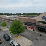 Woodland Crossing, Beauty Supply, Jackson Hewitt, Bella Brows, Kroger main entrance and parking lot aerial view.