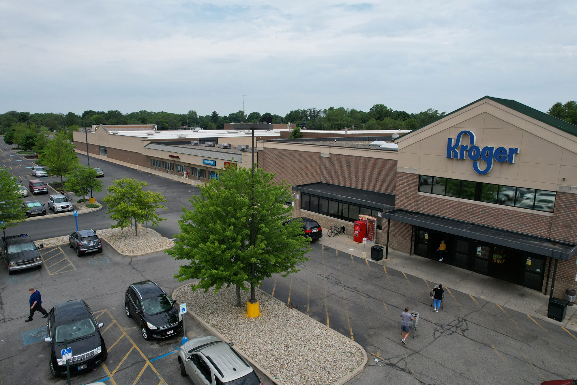 Woodland Crossing, Beauty Supply, Jackson Hewitt, Bella Brows, Kroger main entrance and parking lot aerial view.