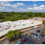 Gainesville Shopping Center, H&R Block, Rent A Center, Pizza Hut, Rainbow, Liquor and parking lot aerial view.