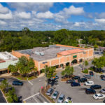 Gainesville Shopping Center, China Garden, QNails, Publix, and parking lot aerial view.