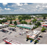 Plymouth Plaza, Planet Fitness, T-Mobile, Dollar General, Advance America Cash Advance, Rent A Center, and Burger King parking lot, aerial view.