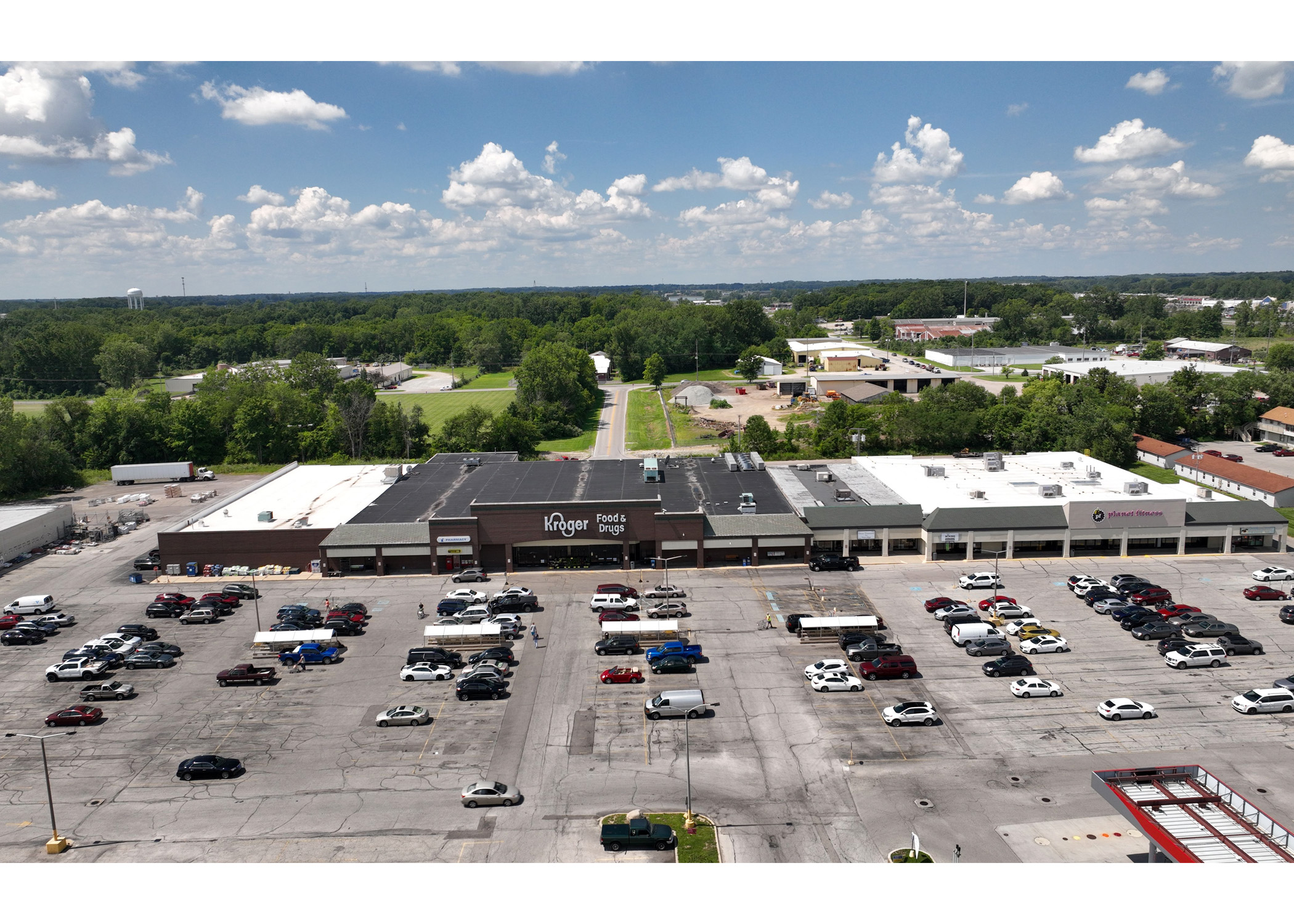 Plymouth Plaza Kroger and Planet Fitness front entrances, and parking lot aerial view.