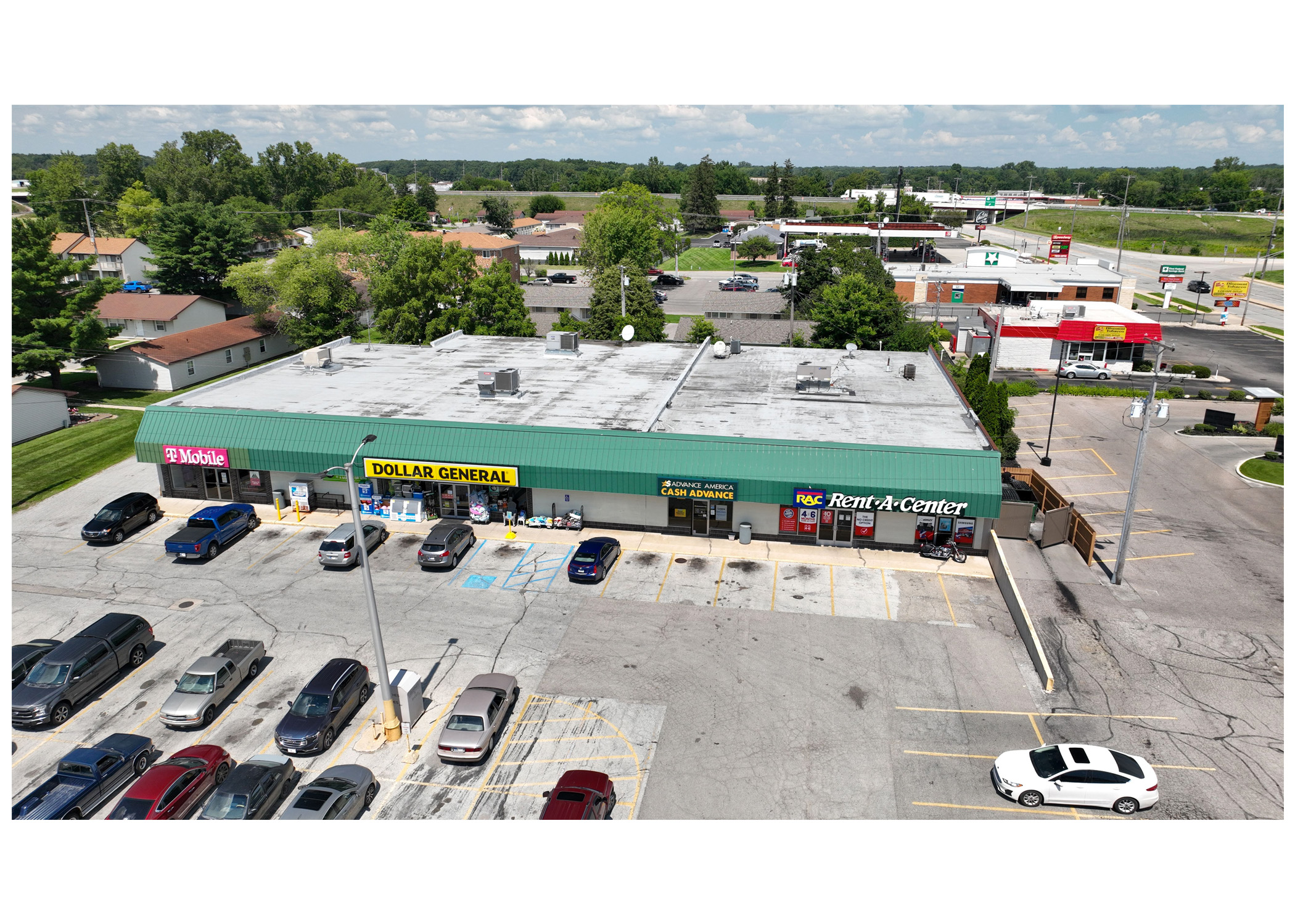 Plymouth Plaza, T-Mobile, Dollar General, Advance America Cash Advance and Rent A Center parking lot, aerial view.