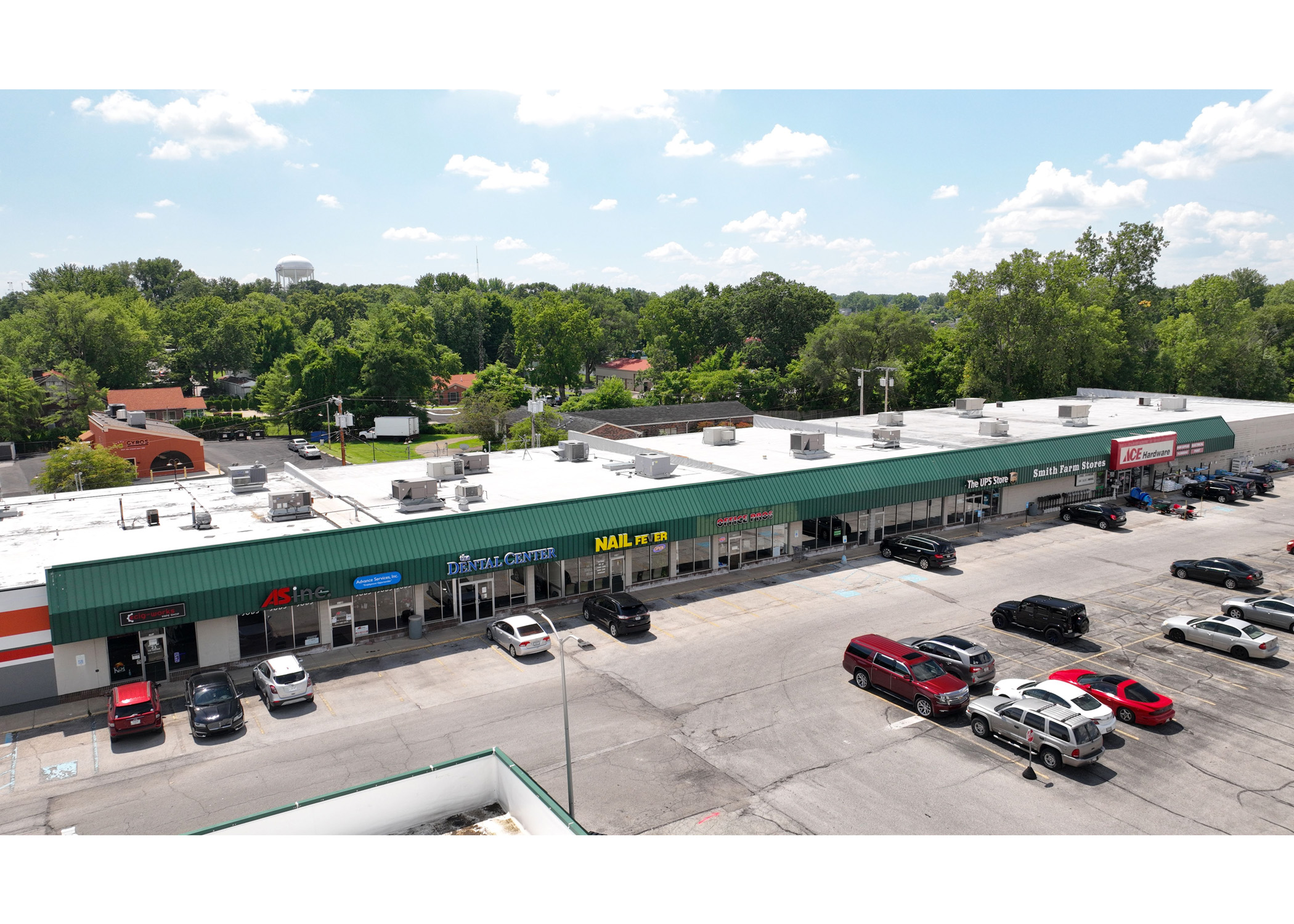 Plymouth Plaza eCig-Works, ASinc, Advance Services, The Dental Center, Nail Fever, Office Pros, The UPS Store, Smith Farm Stores, Ace Hardware parking lot aerial view.