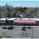 Linwood Square, Rainbow, Ross Dress For Less, and parking lot. Aerial view with Indianapolis skyline behind Rainbow and Ross