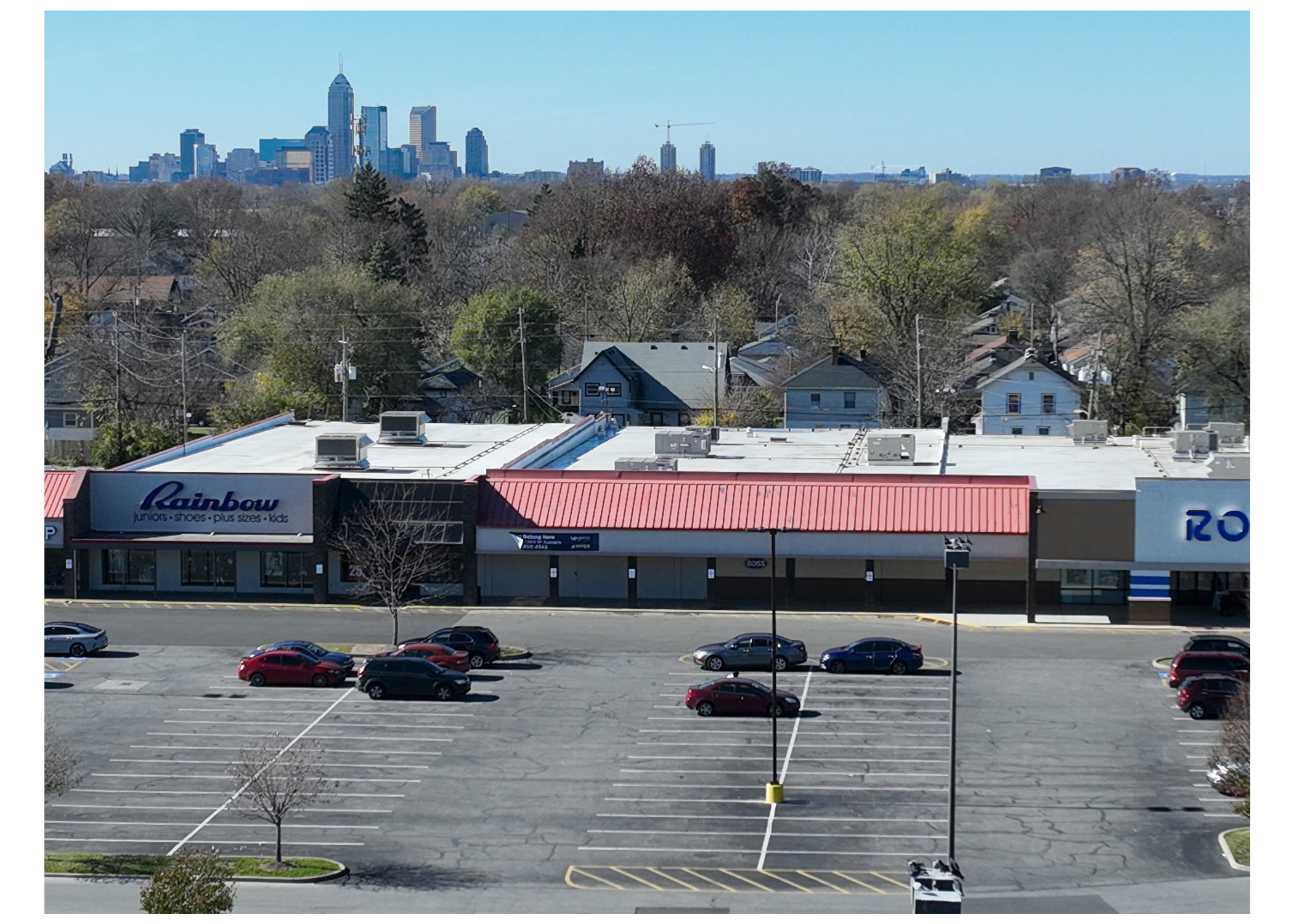 Linwood Square, Rainbow, Ross Dress For Less, and parking lot. Aerial view with Indianapolis skyline behind Rainbow and Ross
