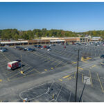 Merchants Square, Rent A Center, New City Buffet, Cato Fashions, USPS Post Office, Top Nails, Western Union, Kroger and parking lot. Aerial view.